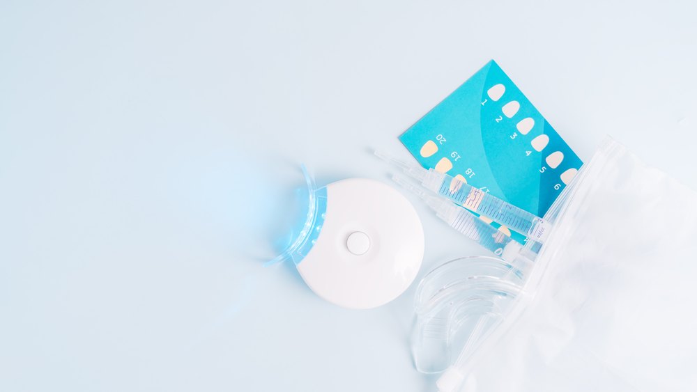 Tray, gel syringes and lamp from an at-home whitening kit